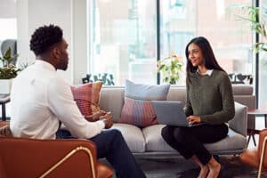 female therapist instructing young man in motivational interviewing techniques