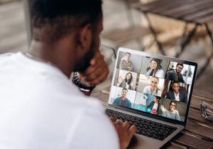 man attending group therapy program virtually on his laptop