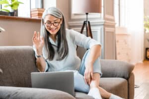 Person talking on video call with her psychotherapist doctor after online therapy sessions, happy that she is well and mentally health now after telemedicine conversations with the providers at Clear Behavioral Health