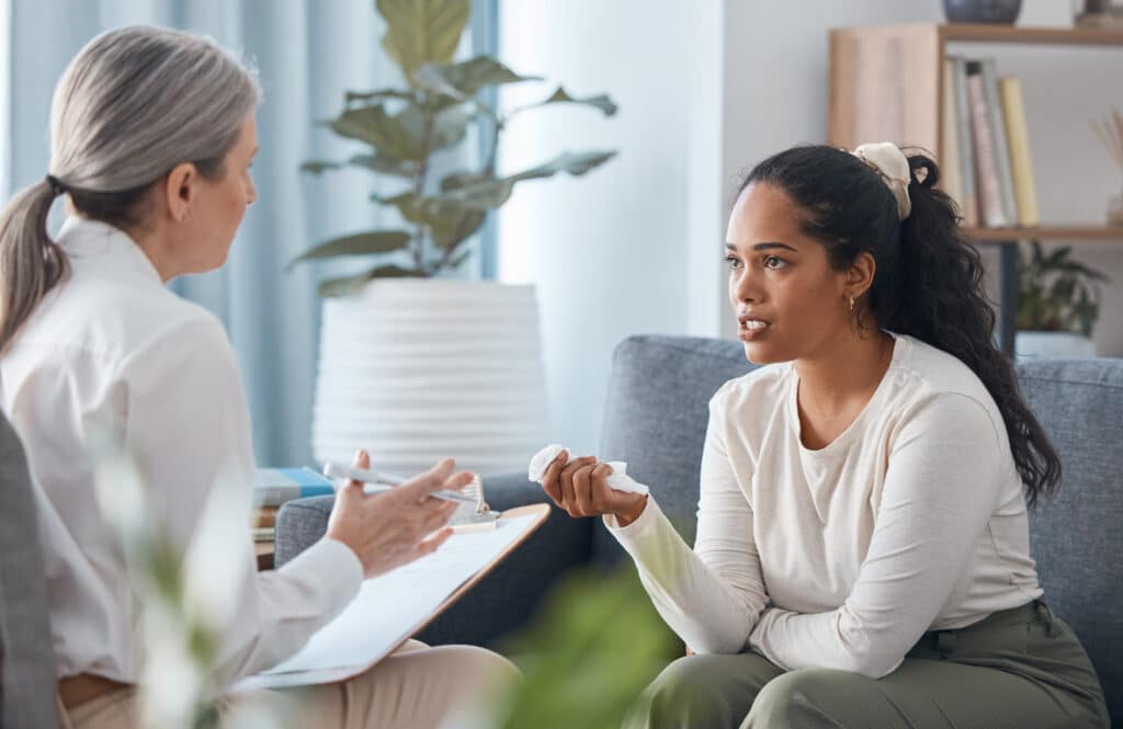 Woman learning about signs she may need to see a therapist.